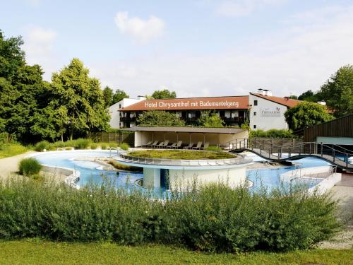 a building with a fountain in front of it at Hotel Chrysantihof in Bad Birnbach