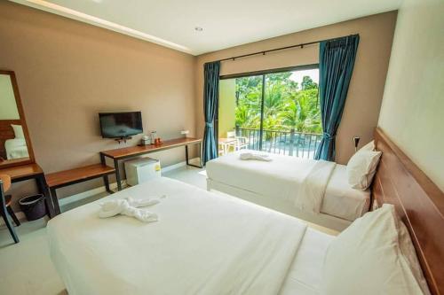 Habitación de hotel con 2 camas y ventana en Saithong Resort en Pak Meng