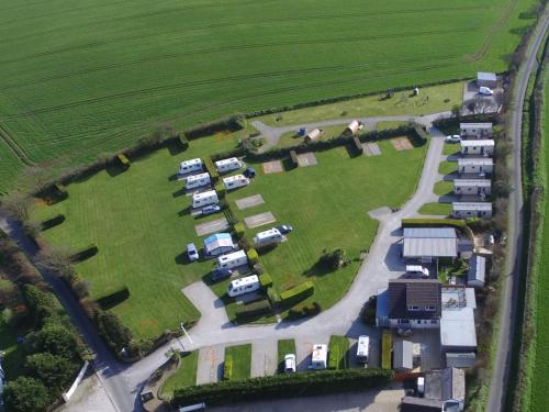 an aerial view of a group of camels in a field at Polborder Holidays Looe Country Park in Looe