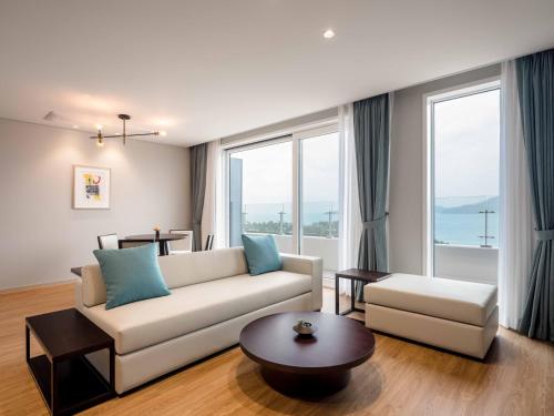 a living room with a couch and a table at Hanwha Resort Geoje Belvedere in Geoje 