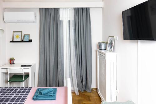 A television and/or entertainment centre at Cozy Studio in the center of Athens