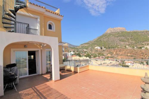 a balcony of a house with a view of a mountain at MONTESOL28 in Calpe