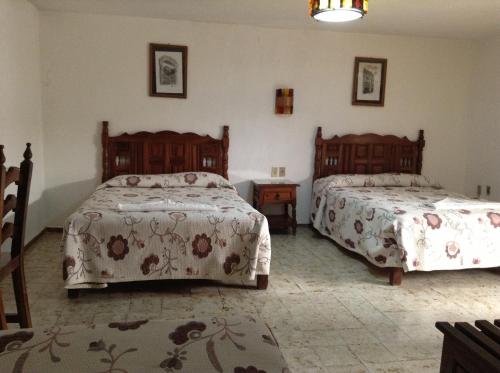 En eller flere senge i et værelse på Hotel Atilanos