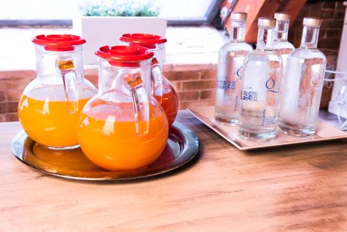a tray with three bottles of orange juice on a table at Hotel Moderno in SantʼAntìoco