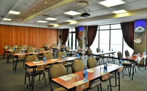 a conference room with tables and chairs and windows at BON Hotel Waterfront Richards Bay in Richards Bay