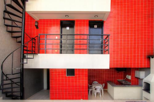 a building with red tiled walls and a staircase at Bristol Metropolitan Curitiba Centro in Curitiba