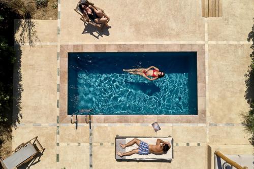 an overhead view of two people swimming in a pool at Diles & Rinies in Tinos Town