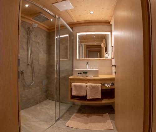a bathroom with a shower and a sink at Gasthof Tannen - Alm in Stummerberg