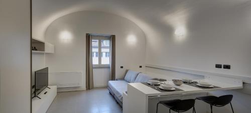 a living room with a couch and a table with chairs at QUADRATO in Turin