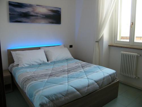a bedroom with a bed with a blue comforter at Residenza Acqua Terra Fuoco in Como