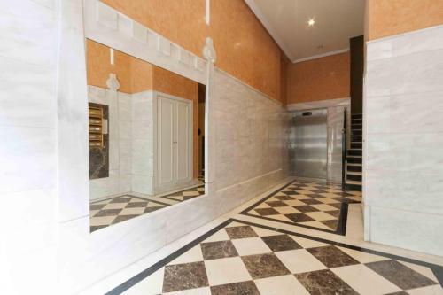 un corridoio con pavimento a scacchi in una casa di The Rentals Collection | Zubieta a San Sebastián