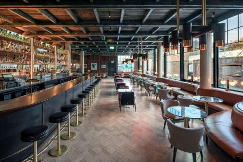 a restaurant with tables and chairs and a bar at The Devlin Dublin in Dublin