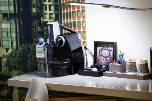 a desk with a phone and other items on it at Mercure Paris Vaugirard Porte De Versailles in Paris