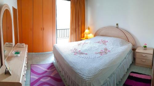 a bedroom with a bed and a dresser and a window at AlSaeed Residence in Jounieh