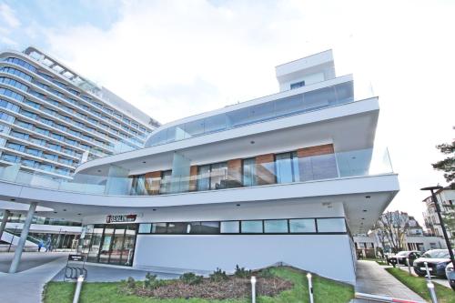 a large building in front of a parking lot at Baltic Park Molo by Baltic Home in Świnoujście