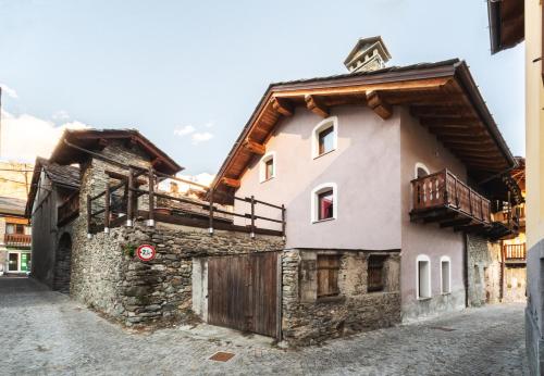 una casa en un pueblo con una puerta de madera en Appartamenti Relax Nus, en Nus