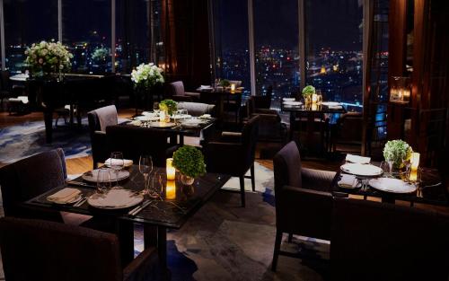 a restaurant with tables and chairs with a view of the city at Shangri-La The Shard, London in London
