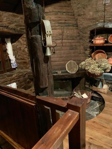 a room with a bench and a table and stairs at Casa do Tanque in Lousã