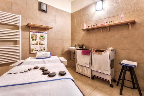 a hospital room with two beds and a sink at Hotel Mondolé - Azzurro Club in Prato Nevoso