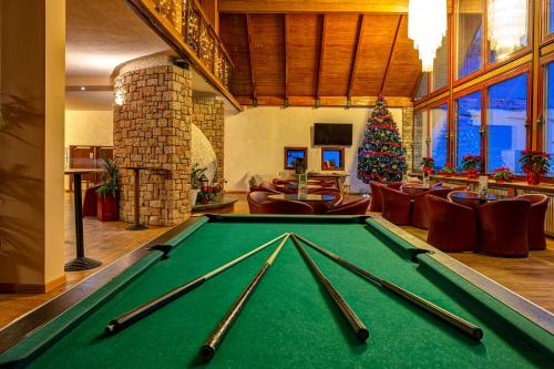 a pool table in a room with a christmas tree at Hotel Mondolé - Azzurro Club in Prato Nevoso