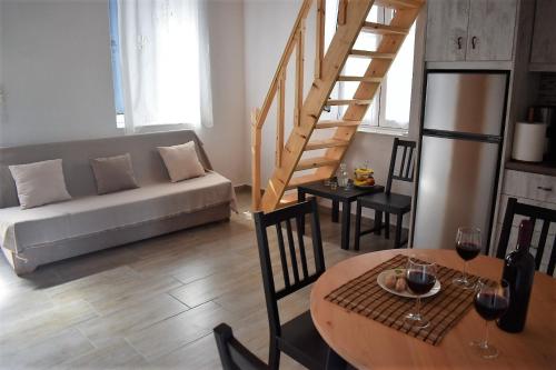 a living room with a couch and a table at Christos Raches traditional houses in Raches