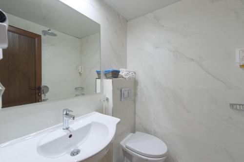 a bathroom with a sink and a toilet and a mirror at Spa Hotel Spartak in Sandanski