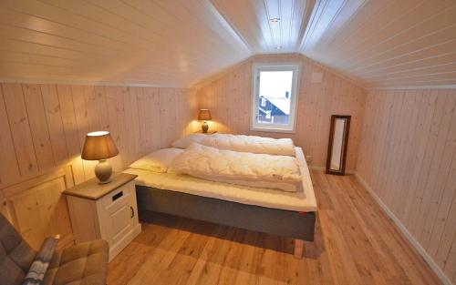 a bedroom with a bed in a room with a window at Golfvegen 76 in Trysil