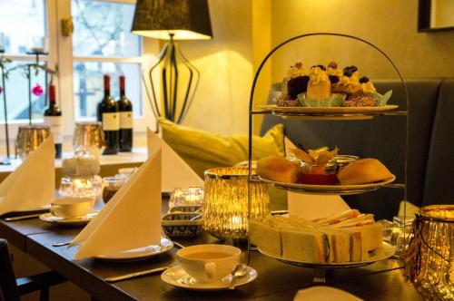 a table with a plate of food on a shelf at Galerie Hotel in Paderborn