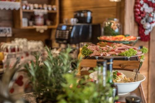 a buffet with several plates of food on a table at Villa Adamo & Relax in Zakopane