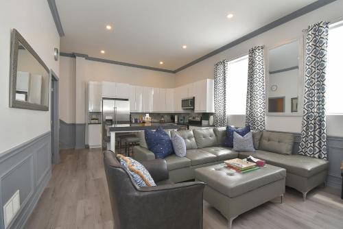 a living room with a couch and a table at The SoMa Furnished Residences in Hamilton