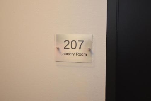 a sign on the door of a library room at The SoMa Furnished Residences in Hamilton