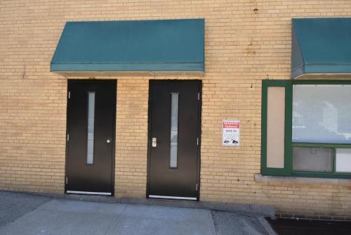 two entrances to a brick building with two doors at The SoMa Furnished Residences in Hamilton