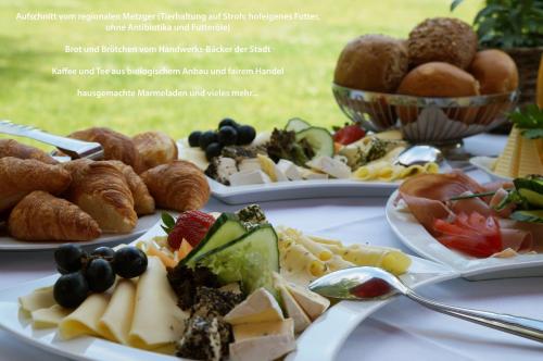 a table with three plates of food on it at Galerie Hotel in Paderborn