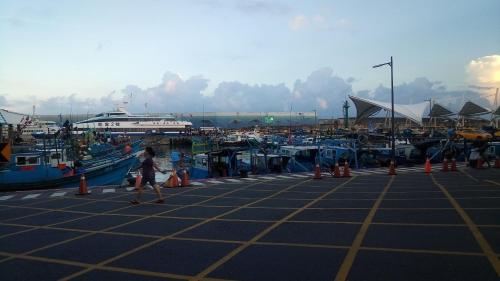 a woman walking past a marina with boats at Blakfoot B&B in Taitung City