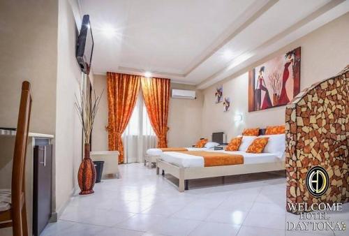 a bedroom with two beds and a television in it at Hotel Daytona Palace in Casoria