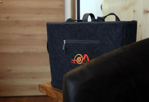 a black briefcase sitting on a wooden table at Boutique Hotel Längenfelder Hof in Grainau