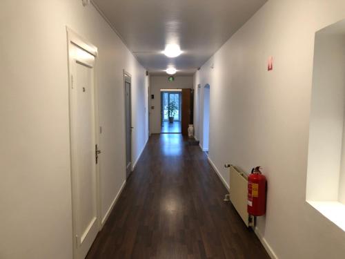 a long hallway with white walls and a hard wood floor at Hotel Aulum Kro in Avlum