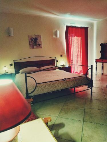 a bedroom with a bed and a red curtain at B&B Sud e Magia in San Pietro Infine