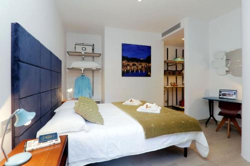 a bedroom with a large bed with a desk and a desk at Rome Unique Monti Colosseum in Rome