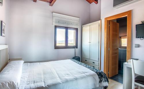 a bedroom with a bed and a window at Reinosa Atalaya-La Vega in Reinosa