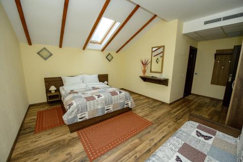 a large bedroom with a bed and a window at Casa Bucatarului in Bălnaca