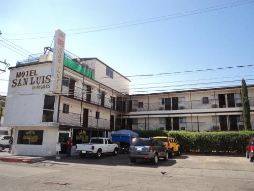 a hotel with cars parked in front of a building at Hotel San Luis de Nogales in Heroica Nogales