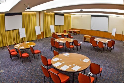 a conference room with tables and chairs and whiteboards at Novotel Sao Paulo Morumbi in Sao Paulo