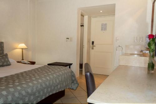 a hotel room with a bed and a sink at O2 Hotel Buenos Aires in Buenos Aires