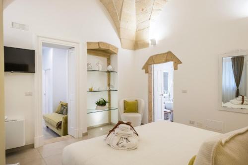 a bedroom with a bed with a bag on it at Amatè Suite in Lecce