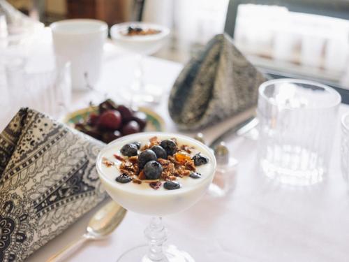 a bowl of food on a table with a plate of fruit at Burdett House Bed & Breakfast in Burdett