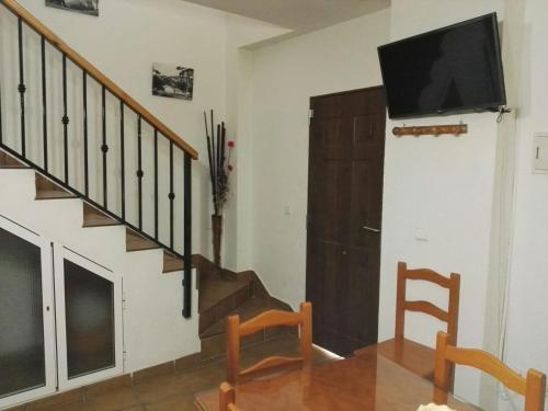 a living room with a flat screen tv on the wall at Del Romero in Arroyo Frio