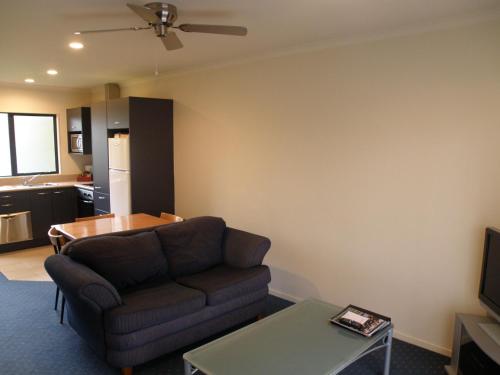 a living room with a couch and a table at Stadium Motel in Hamilton