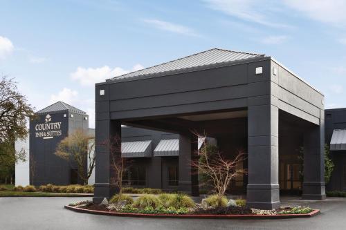 a black building with a sign in front of it at Country Inn & Suites by Radisson, Seattle-Bothell, WA in Bothell