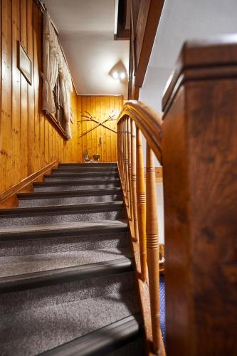 a staircase in a building with wooden walls at Hotel Sonnenhalde, Arosa in Arosa
